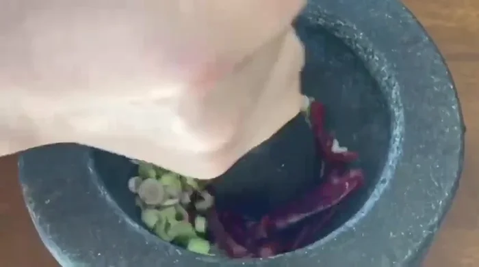 Add the pork offal to the pot and stir-fry until lightly browned. [This step is inferred from the video and common Aom Kreuang Nai Moo preparation.]