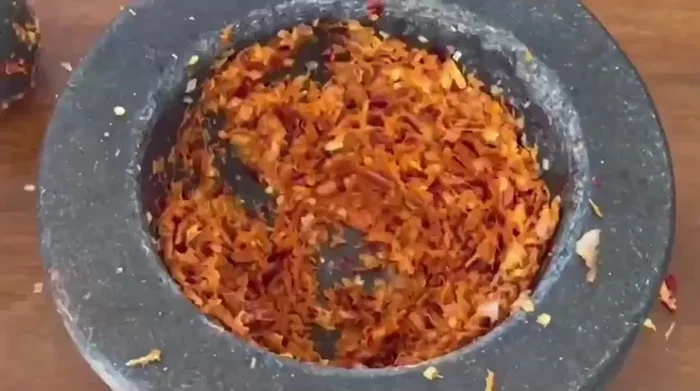 Add fish sauce, soy sauce, and palm sugar to taste. [This step is inferred from the video and common Aom Kreuang Nai Moo preparation.]