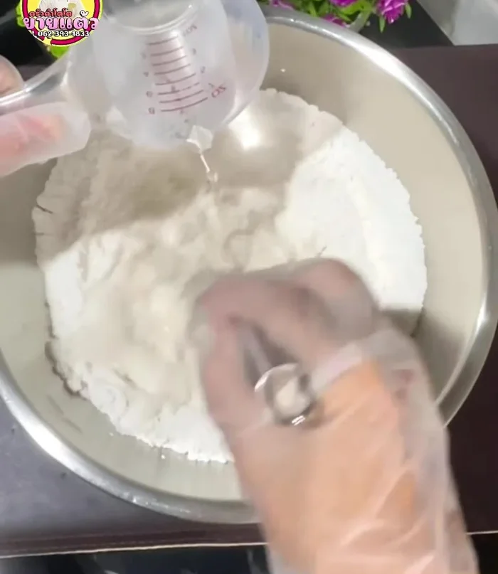 Gradually add lime water and stir until well combined. (Details on lime water ingredients are at the end of the clip)