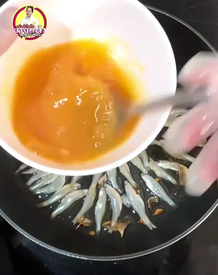 Gently pour the egg mixture over the fish, using a spoon to avoid breaking the fish. This creates a beautiful circular omelet.