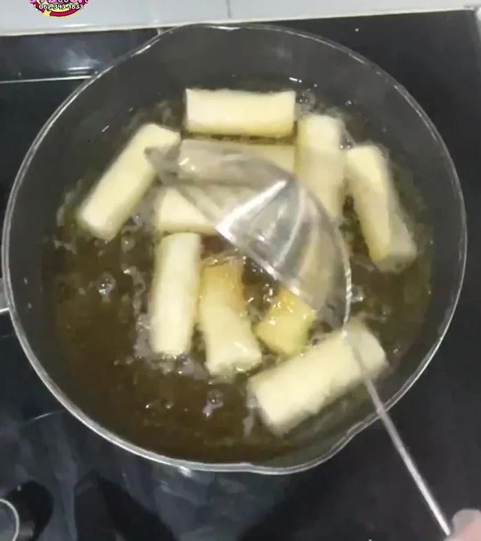 Fry the spring rolls in hot oil over medium heat until golden brown and crispy.
