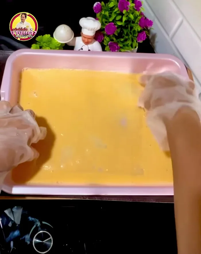 Add Vietnamese rice paper sheets one by one, dipping each sheet into the egg mixture and turning it over to coat thoroughly. Stack 3 sheets together.