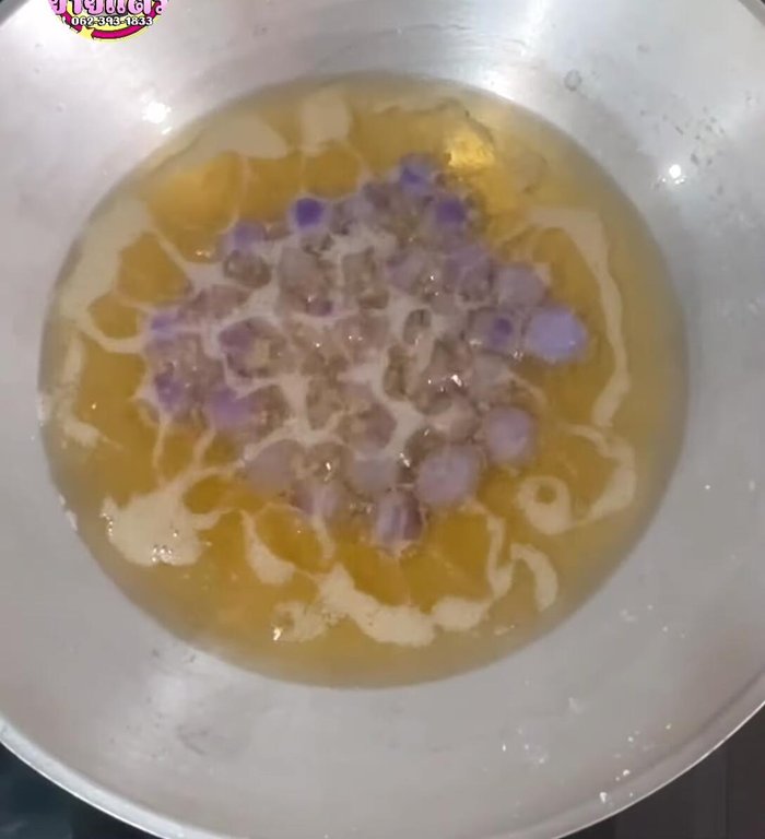 Once the cakes start to float, gently press them down with a sieve or strainer to flatten and ensure they puff up evenly. Repeat this process until the cakes are golden brown.