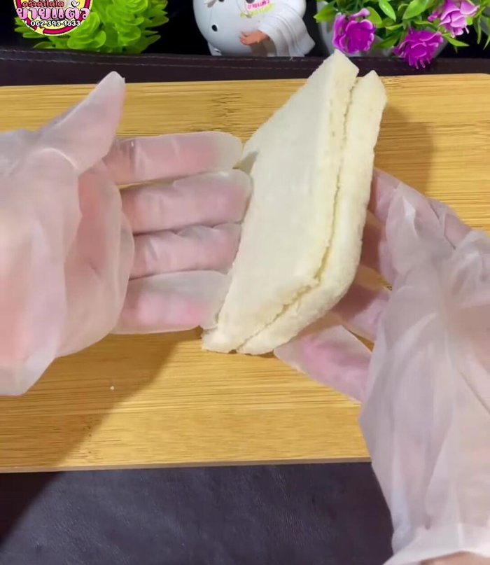 Take 2 slices of bread and press them together. If using bread with edges, no need to cut them off.