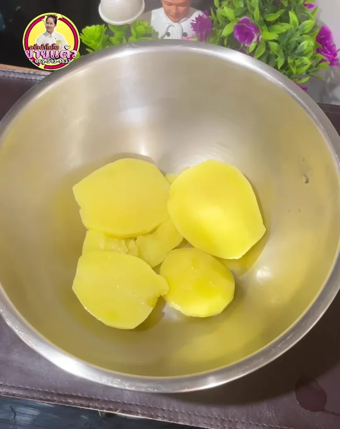 Mash the potatoes while still hot. A masher or spatula works well.