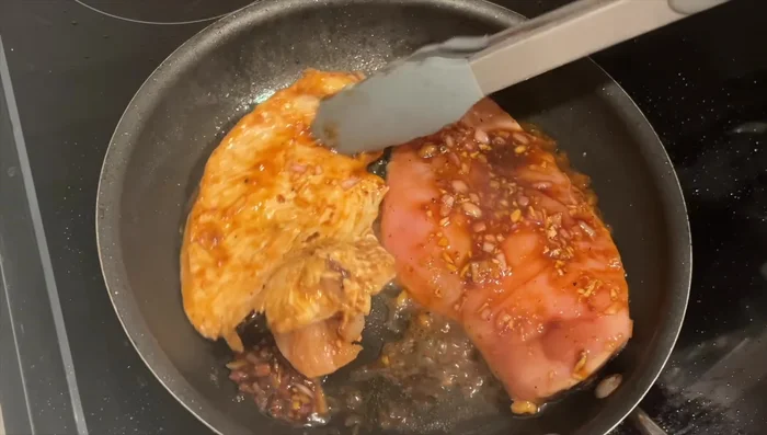 Add some of the marinade to the pan, cover with a lid to steam, and cook until fully done.