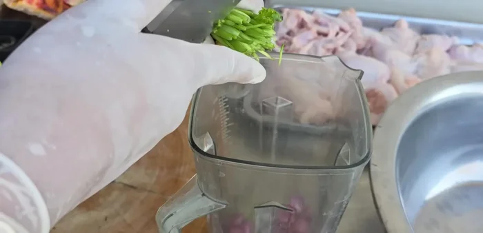 Prepare the marinade: Blend garlic, shallots, vegetable roots, galangal, lemongrass, coriander seeds, fresh milk, water, pepper, chicken flavoring, salt, palm sugar, granulated sugar, fish sauces (green and white-capped), and Nua powder until smooth.