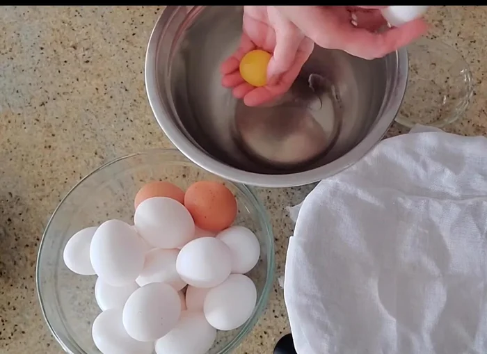 Crack 18 eggs, separating egg whites, yolks, and any bits of egg shell.