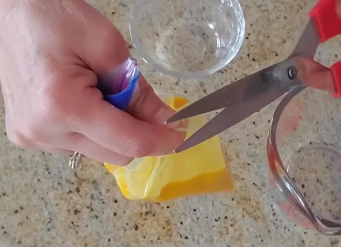 Test the flow of the egg yolk mixture. It should create a long, thin stream.