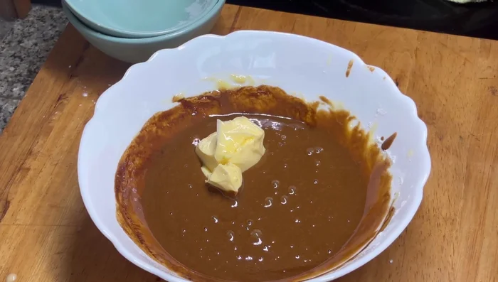 Add softened unsalted butter to the coffee mixture and mix until smooth.