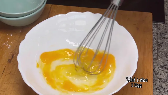 Prepare the pandan flavor: Whisk 1 egg, add salt, and mix well. Then add pandan extract/water, icing sugar, and all-purpose flour. Mix well.