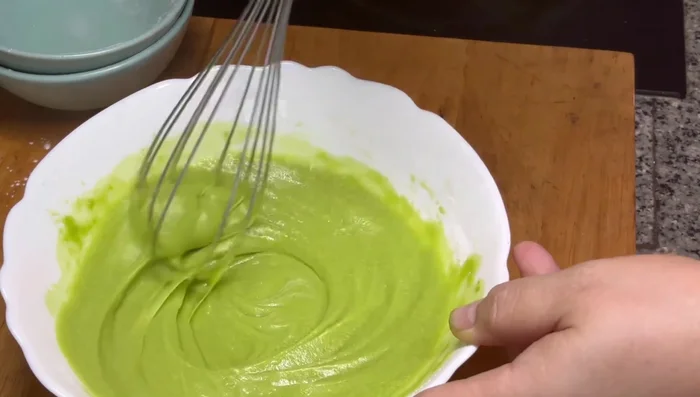 Add softened unsalted butter to the pandan mixture and mix until smooth.