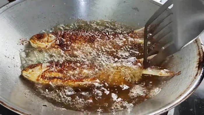 Fry the carp in batches until golden brown on both sides. Because we only have enough oil for 2 pieces per pan, we keep frying until the other side is cooked.