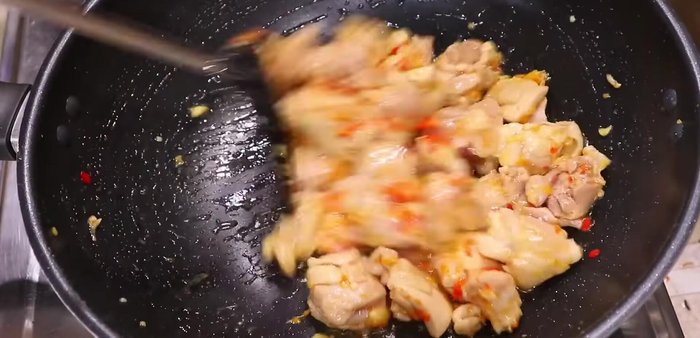 Add the minced garlic and chilies, stir-fry briefly.