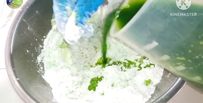 Gradually add pandan leaf water to the glutinous rice flour, kneading until a sticky and soft dough forms.