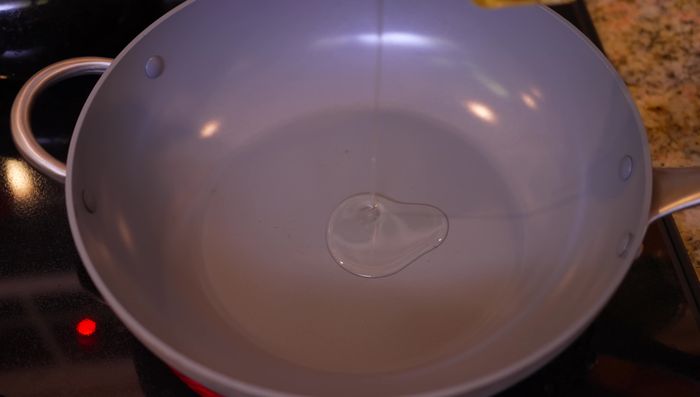 Heat vegetable oil in a pan over medium heat.