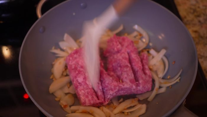 Add ground pork and cook until halfway done.