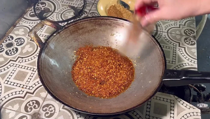 Once the oil is warm, add the chili peppers and stir-fry until fragrant. Use very low heat.