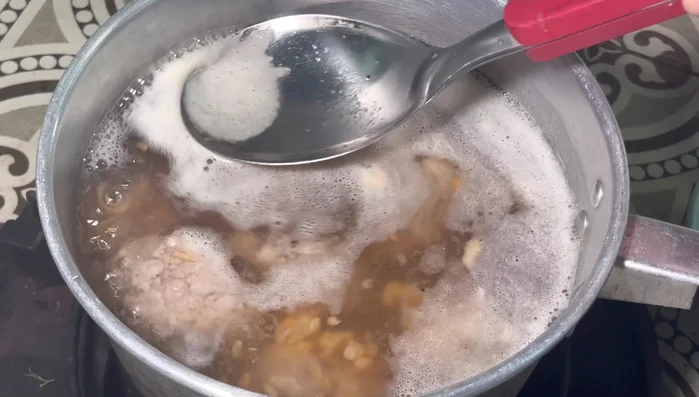 Once the water boils, skim off the foam and turn the heat to medium-low.