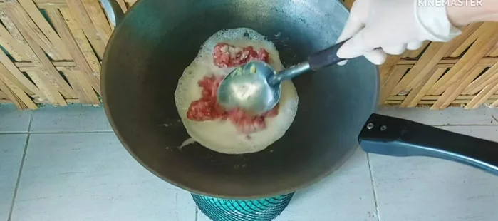 Slowly add coconut milk while stirring. Add minced pork and stir-fry until cooked.