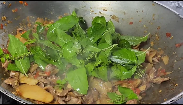 Add basil leaves and stir-fry until wilted.