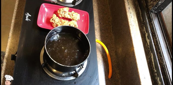 Remove chicken from oil and drain on a strainer.