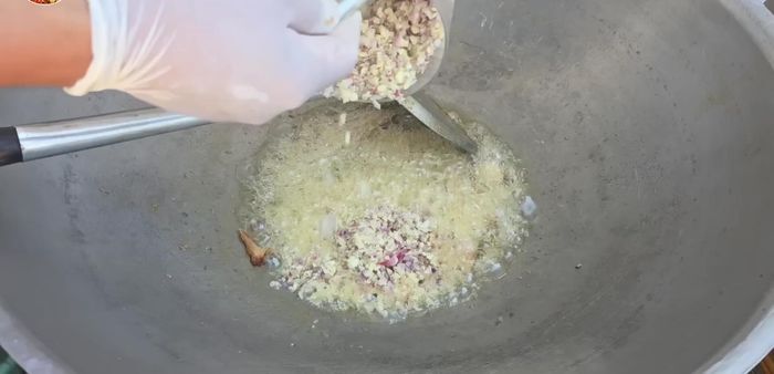 Cook the rice: Fry ginger, shallots, and garlic, then add rice and chicken broth.