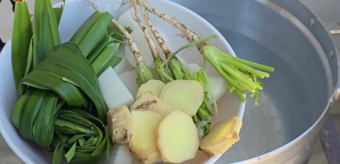 Prepare the chicken rice: Boil water with pandan leaves, salt, chicken, and radish & coriander root.