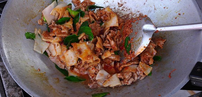 Add water, palm sugar (or granulated sugar), fish sauce, and oyster sauce. Stir-fry until well combined and the palm sugar melts.