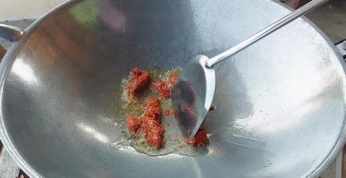 Add red curry paste and stir-fry until fragrant and the oil separates.