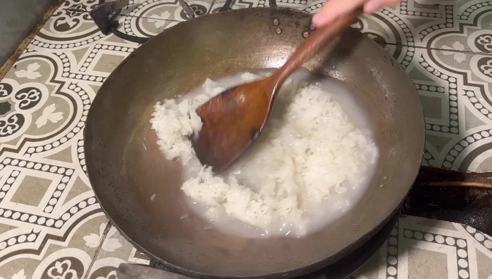 Steam sticky rice until cooked. While still hot, pour the steamed sticky rice into the hot coconut milk mixture.