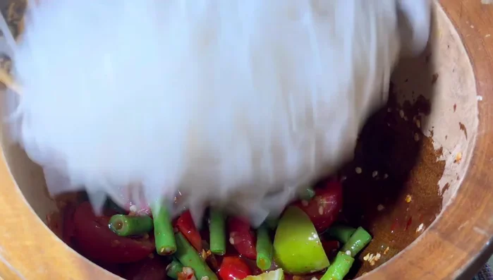 Add boiled thin noodles. Stir gently with a spatula.