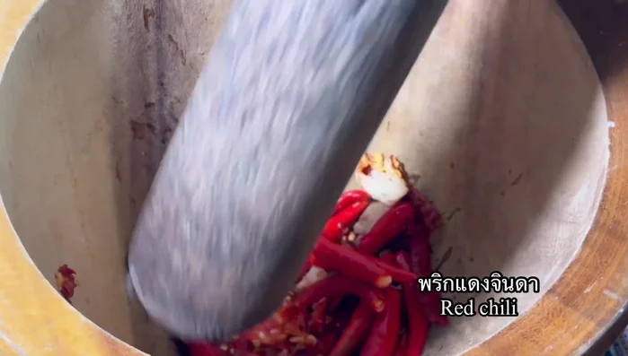 Add red chilies and pound until fine.