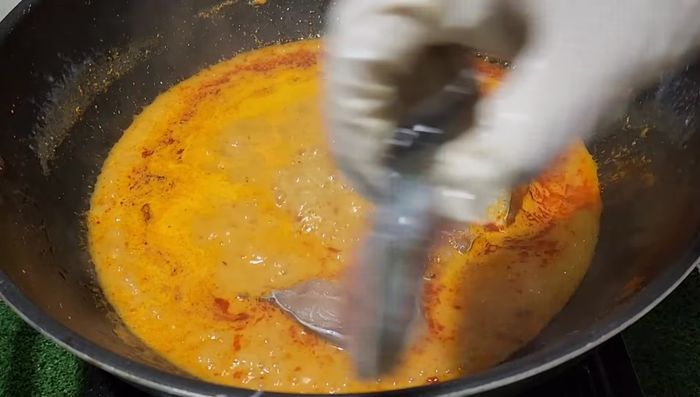 Add the catfish to the simmering coconut milk.