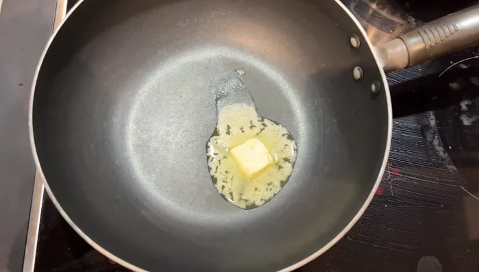 In a pan, add some butter and minced garlic. Wait for the butter to melt.
