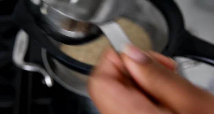 Cook quinoa: Rinse 1 cup uncooked quinoa thoroughly. Heat a pan with oil, toast quinoa until crisp. Add 2 cups water or broth, a pinch of salt, bring to a boil, then simmer covered for 15 minutes. Let it sit until liquid is absorbed, then fluff.