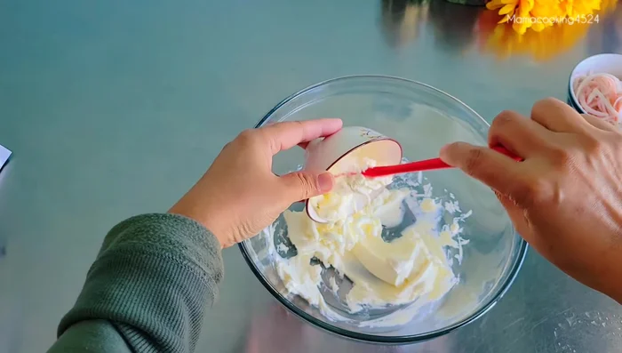 Mix softened cream cheese with mayonnaise (or salad dressing), sugar, corn, shredded crab sticks, and chopped shrimp.