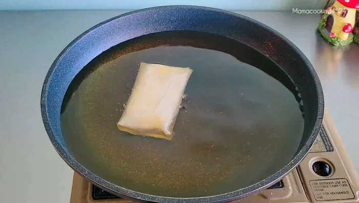 Heat oil in a pan. Fry the spring rolls until golden brown and crispy, flipping carefully to avoid breakage.