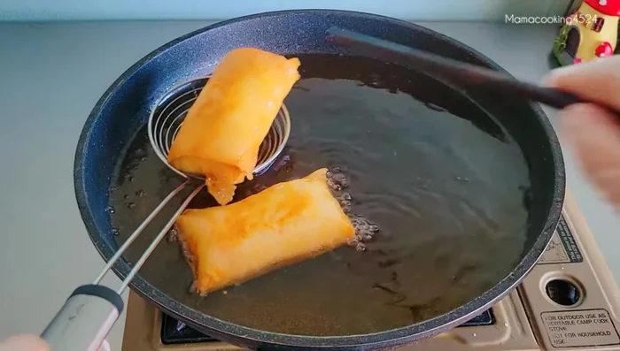 Remove spring rolls from the pan and drain on a wire rack to maintain crispiness.