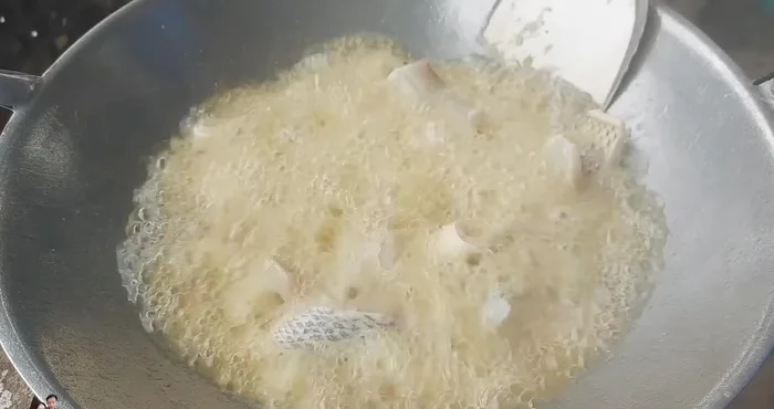 Add the tilapia fillets to the pan and fry until golden yellow and crispy on both sides. It shouldn't stick to the pan.