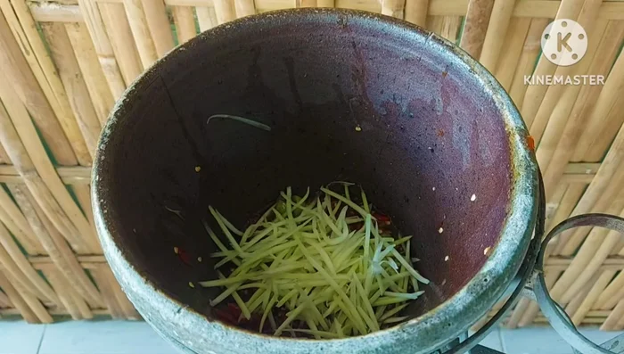 Assemble the Som Tum: Combine the dressed papaya strips with the crispy apple snails, long beans, eggplant, rice vermicelli, bamboo shoots, and any other desired vegetables (e.g., pickled cabbage, bean sprouts). Gently mix everything together.