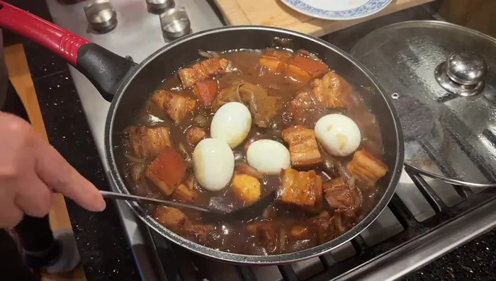 Add hard-boiled eggs, ensuring they are submerged under the liquid. The eggs should turn a brownish color, not white.