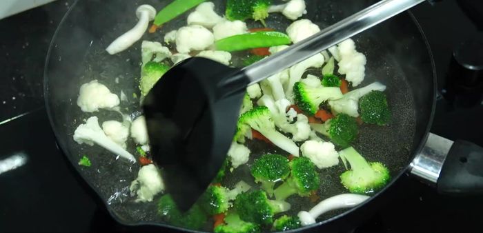 Shock the vegetables: Immediately transfer the cooked vegetables into a bowl of ice water to maintain color and crispness. (102.159, 135.64)