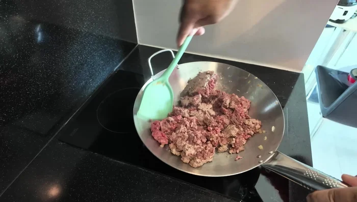 Brown the minced beef in a pan.