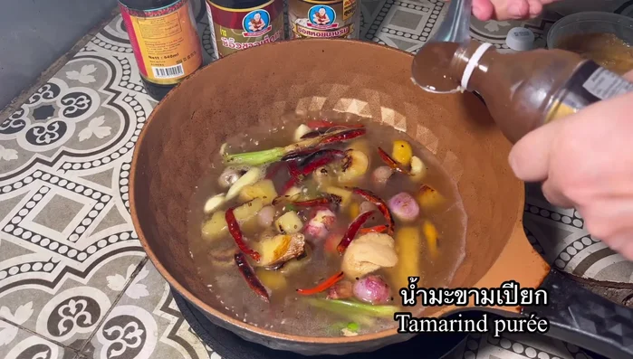 Season with sugar, coconut milk, tamarind juice, oyster sauce, soy sauce, dark soy sauce, and pepper.