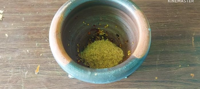 Add the grilled fish to the mortar and pound into a paste.