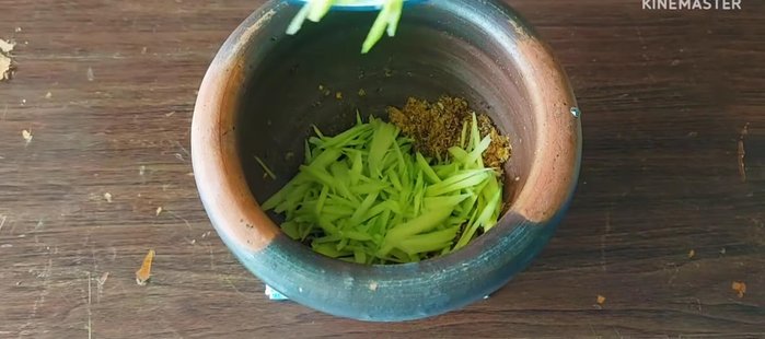 Add the chopped mangoes and pound everything together.