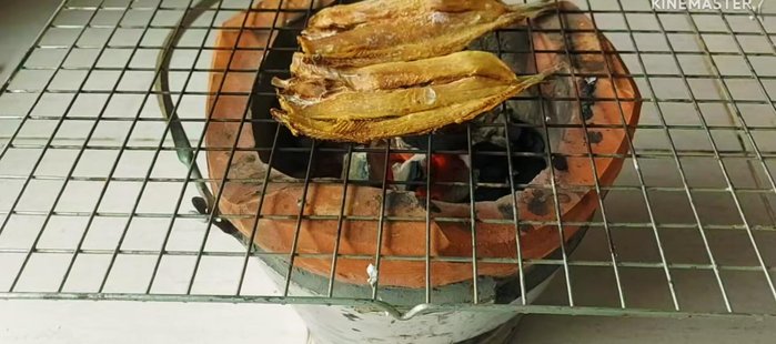 Grill the fish until crispy, keeping the heat low to prevent burning.