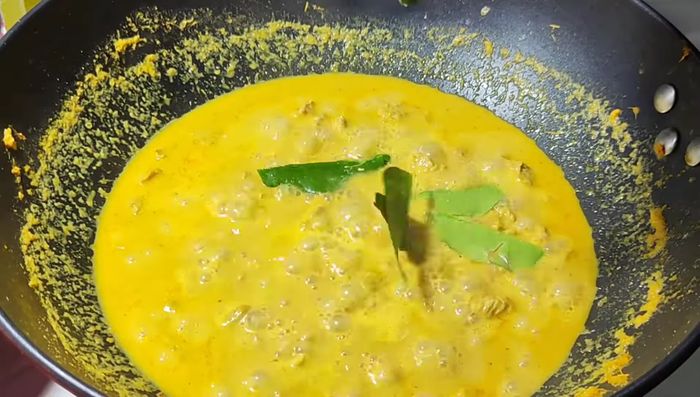 Blanch bamboo shoots in boiling water.