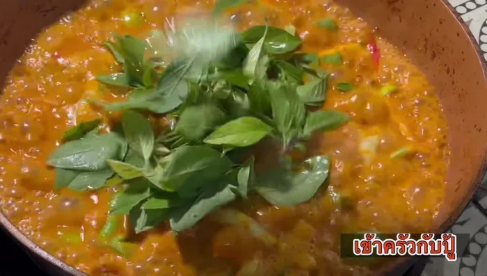 Season with fish sauce, add fresh chili, kaffir lime leaves, and basil leaves. Turn off heat immediately.
